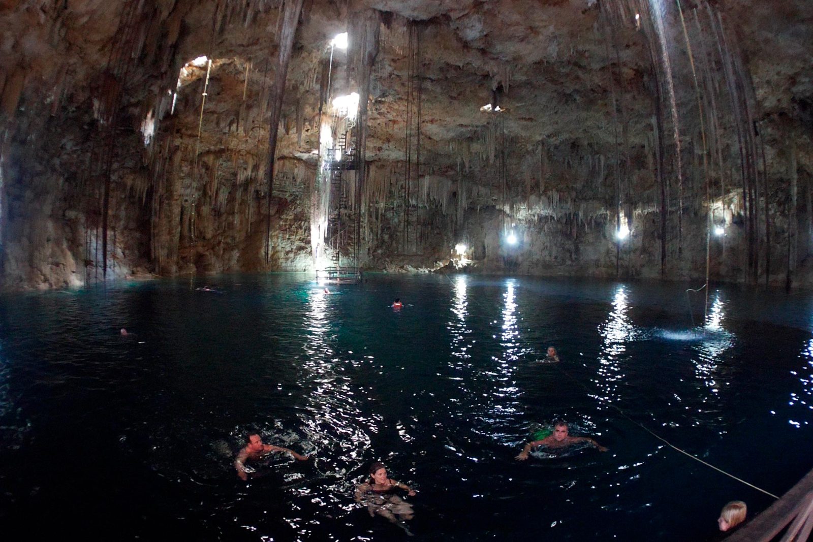 Crystal clear cenote with stalactites