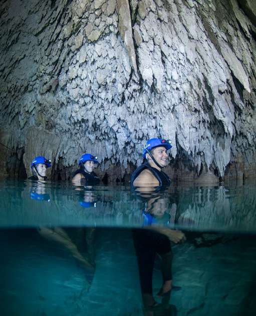 Exploring a crystal clear water cavern at Hidden World